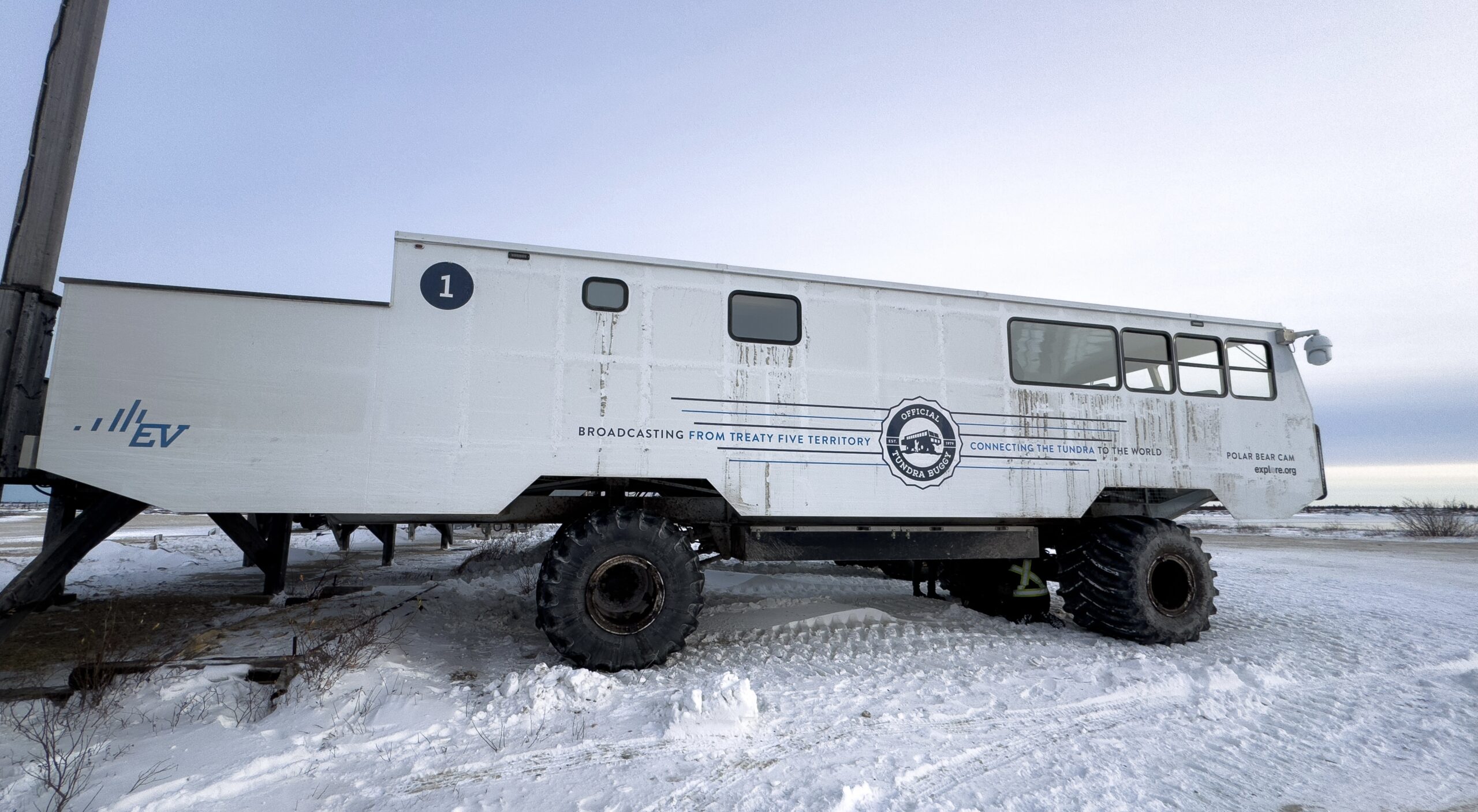 a new all electric tundra buggy ev 1 in churchill manitoba parked at the dock