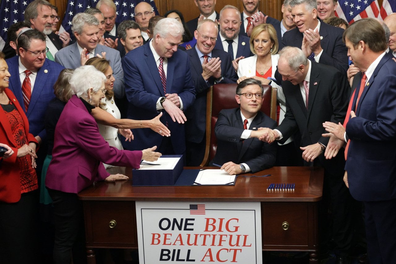 US Speaker of the House Rep. Mike Johnson (R-LA) celebrates with fellow House Republicans during an enrollment ceremony of H.R. 1, the One, Big, Beautiful Bill Act on July 3, 2025 in Washington, DC.